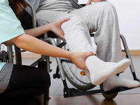 Health practitioner helping an injured patient in a wheelchair